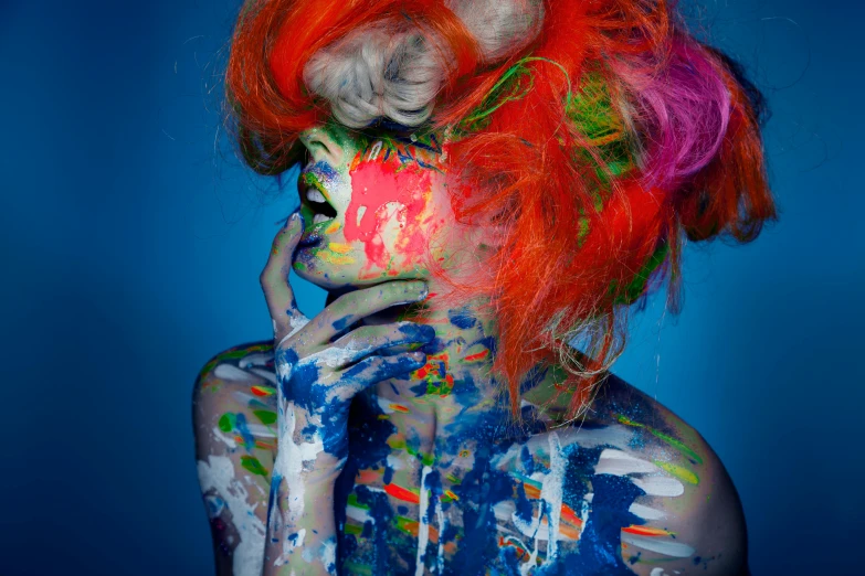 a close up of a person with paint on their face, a pop art painting, inspired by Alberto Seveso, trending on pexels, art photography, messy square vibrant red hair, full body art, blue and orange, grungy woman with rainbow hair