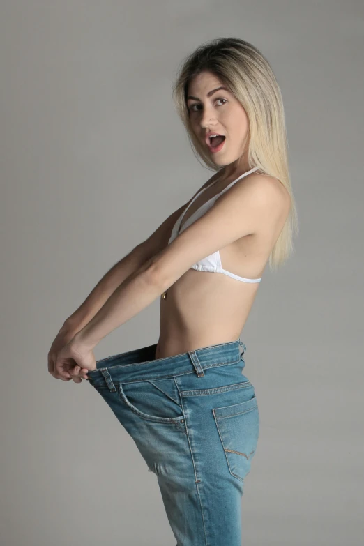 a woman in a white bra top and blue jeans, by Matthias Stom, pexels contest winner, photorealism, a blond, baggy jeans, about to consume you, cut out
