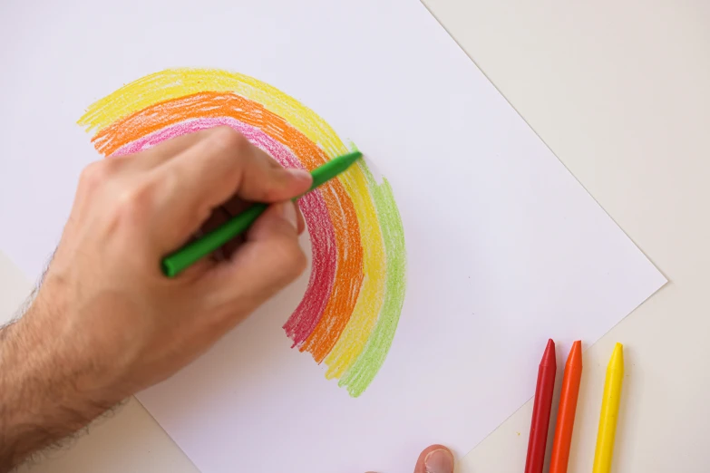 a man is drawing a rainbow with colored crayons, a child's drawing, by Nicolette Macnamara, press shot, minimalistic drawing, caran d'ache luminance, instagram photo