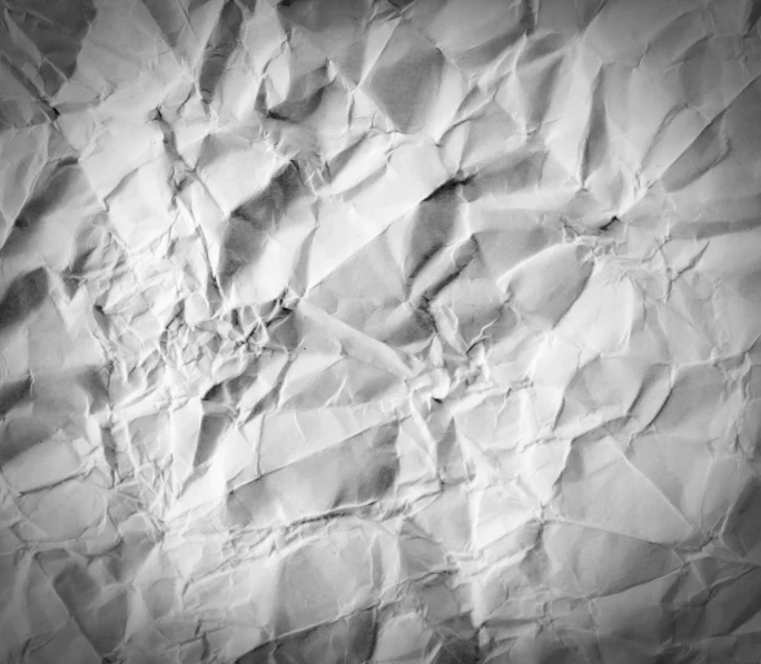 a black and white photo of a crumpled piece of paper, pexels, textured parchment background, background image, brightly-lit, pockets