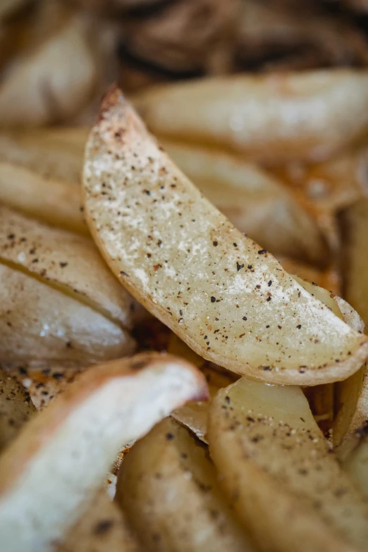 a close up of a pile of french fries, potato skin, metallic flecks, poppy, organics