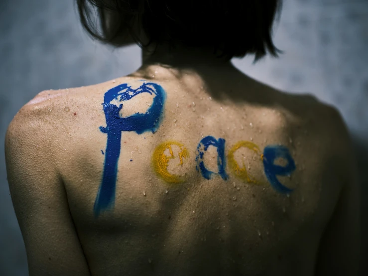 a woman with the word peace painted on her back, inspired by Tracey Emin, pexels contest winner, avatar image, color ( sony a 7 r iv, mixed art, thumbnail