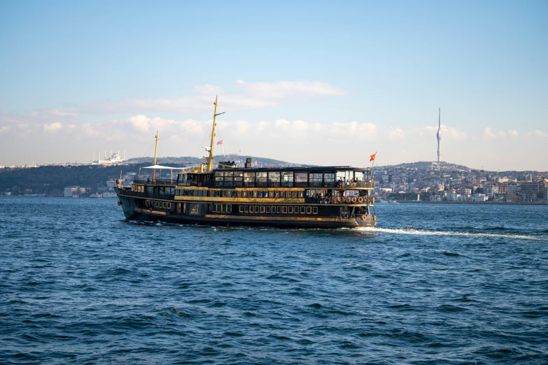 a large boat traveling across a large body of water, by Julia Pishtar, pexels contest winner, hurufiyya, istanbul, gold and black color scheme, 256x256, navy