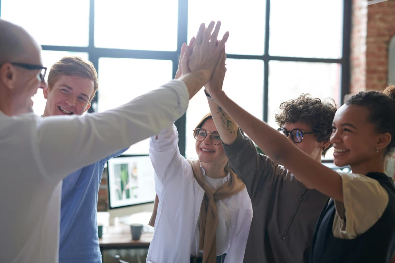 a group of people giving each other a high five, pexels contest winner, renaissance, in an office, avatar image, attractive photo, lachlan bailey