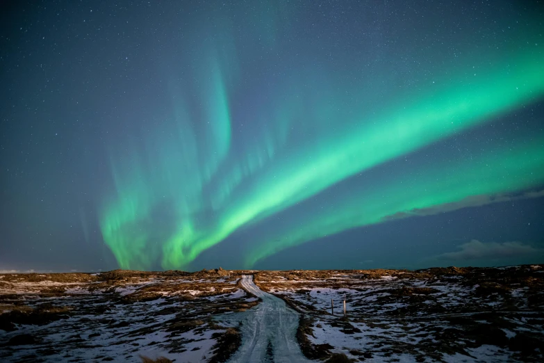 the aurora bore lights up the sky over a snowy landscape, an album cover, pexels contest winner, hurufiyya, square, high quality photo, blue and green light, road