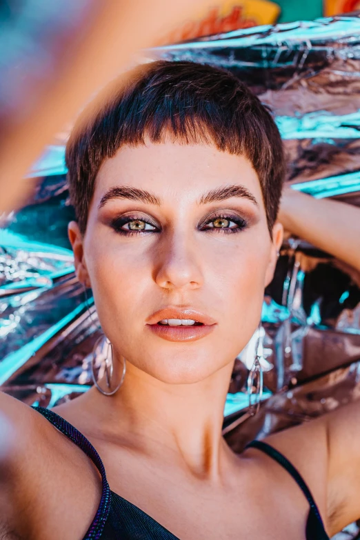 a woman holding an umbrella over her head, an album cover, by Julia Pishtar, trending on pexels, short black pixie cut hair, sasha grey, closeup headshot portrait, brazilan supermodel