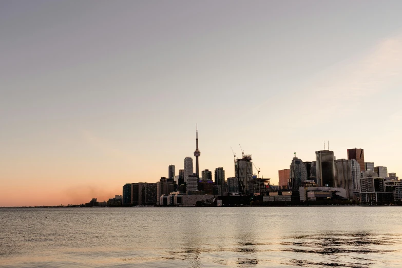 a large body of water with a city in the background, by Carey Morris, pexels contest winner, hurufiyya, toronto, taken at golden hour, where a large, conde nast traveler photo