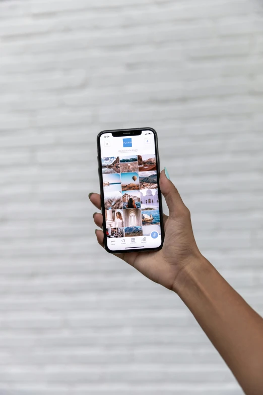 a person holding a cell phone in their hand, trending on unsplash, 2 5 6 x 2 5 6 pixels, blue image, lots of pictures, instagram post