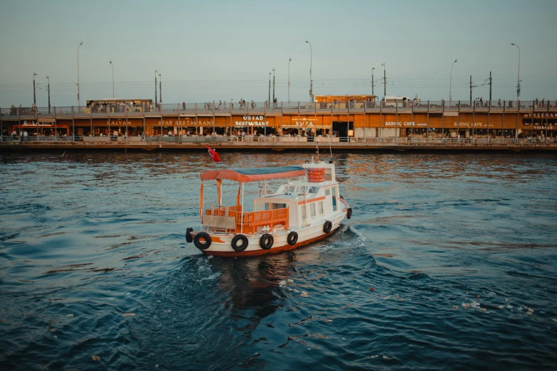 a boat floating on top of a body of water, by Julia Pishtar, pexels contest winner, hurufiyya, istanbul, thumbnail, brown, near a jetty