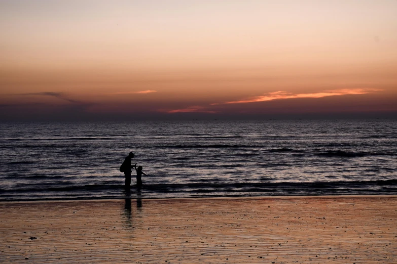 a couple of people standing on top of a sandy beach, by Jan Tengnagel, pexels contest winner, minimalism, dusk setting, omaha beach, children playing at the beach, thumbnail