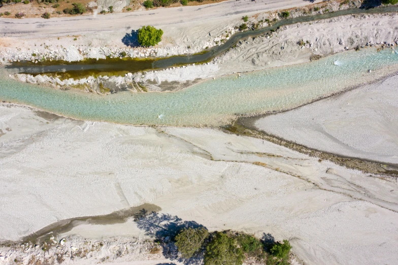 an aerial view of a river running through a desert, by Francesco Furini, figuration libre, calanque, white clay, alexandros pyromallis, smelting pit'beeple