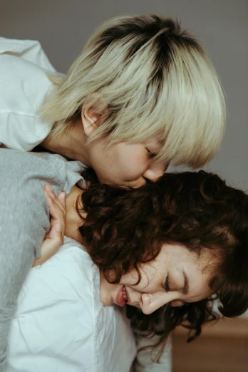a woman hugging a little girl on top of a bed, trending on pexels, yoshitomo nara and aya takano, curly white hair, profile image, lesbians