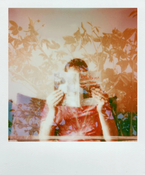 a person taking a picture with a camera, a polaroid photo, inspired by Elsa Bleda, happening, faded red colors, transparent face, julia sarda, psychedelic photoluminescent