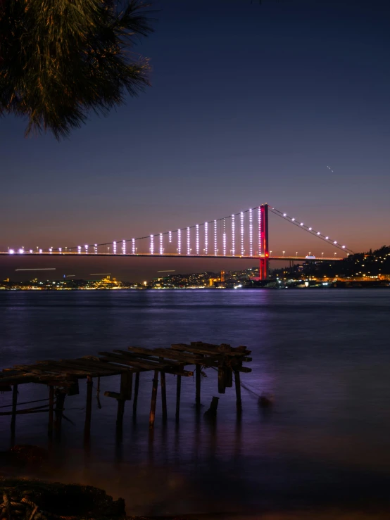 a body of water with a bridge in the background, by Nabil Kanso, pexels contest winner, hurufiyya, led light strips, turkey, pink arches, post+processing