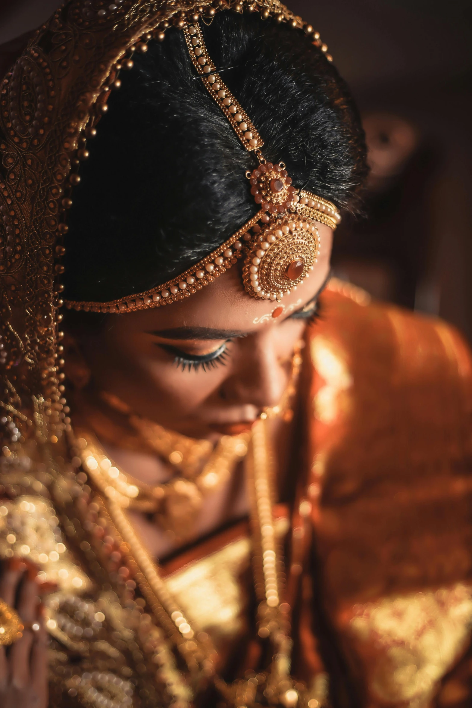 a close up of a woman in a gold dress, pexels contest winner, hurufiyya, dressed in a sari, bride, contemplating, [ cinematic