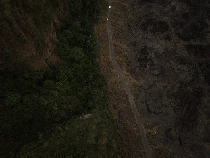 an aerial view of a winding road in the mountains, an album cover, pexels contest winner, hurufiyya, by emmanuel lubezki, todd hido photography, kauai, distant full body view