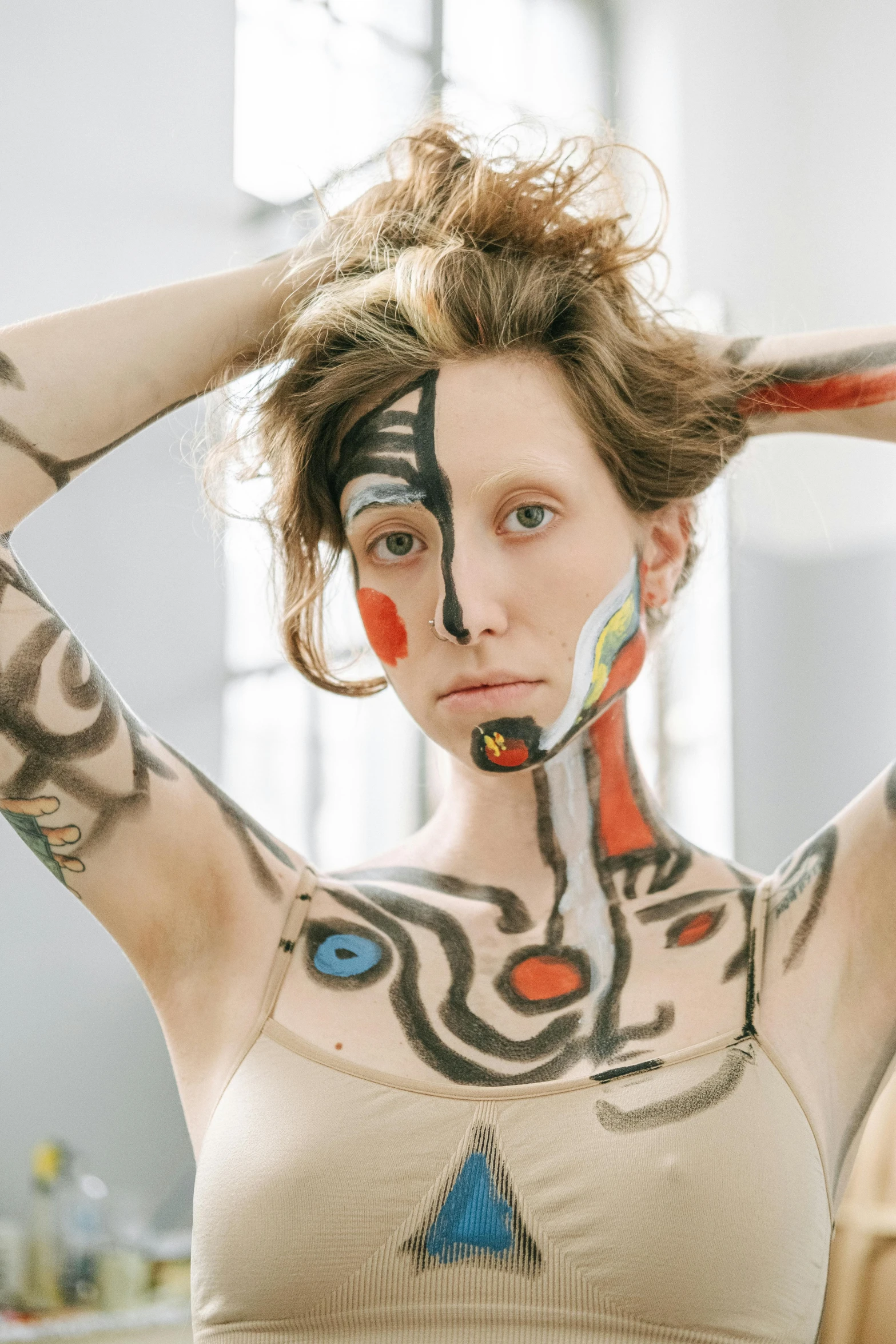 a woman that has some paint on her face, a tattoo, inspired by Egon Schiele, trending on pexels, renaissance, patricia piccinini, attractive androgynous humanoid, square, body and torso