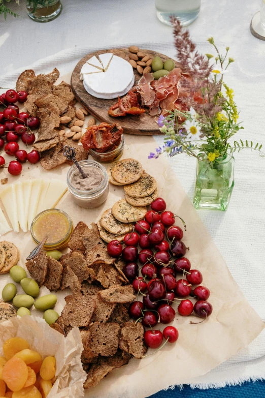 a table topped with lots of different types of food, a still life, cherry, flat lay, grazing, cheesy