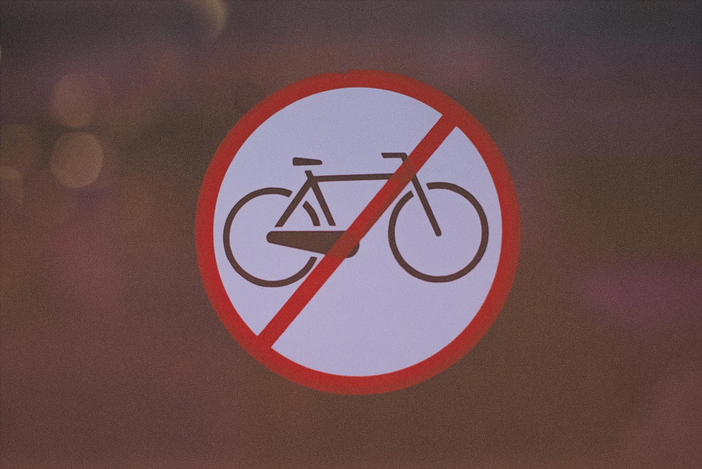 a close up of a sign with a bike in it, a poster, unsplash, plasticien, forbidden, no - text no - logo, avatar image, brown