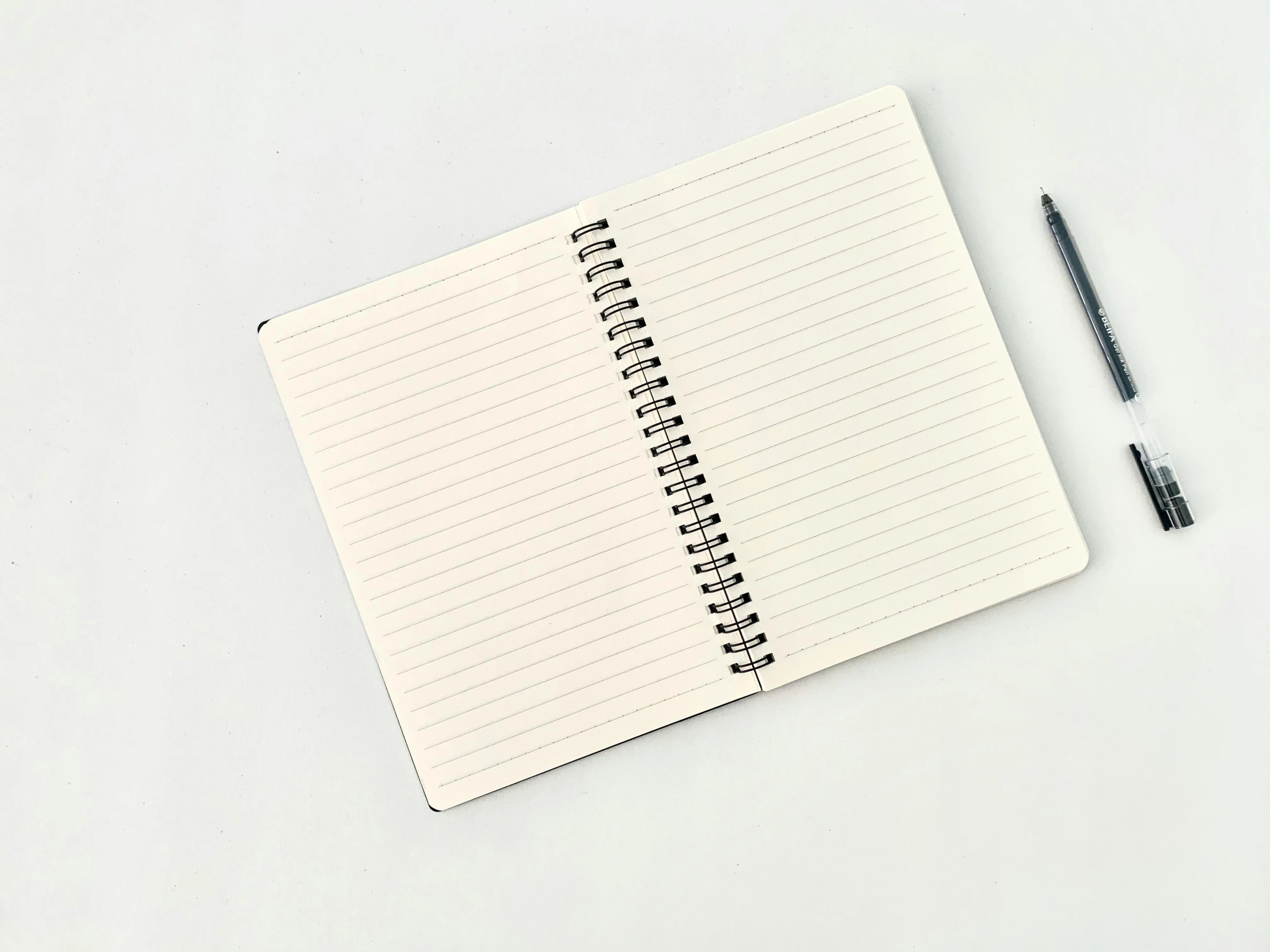 a notepad with a pen on top of it