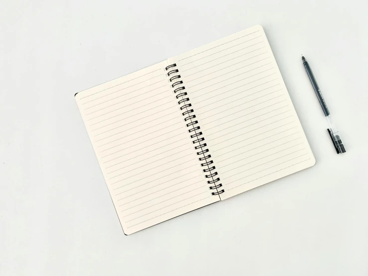 a notepad with a pen on top of it