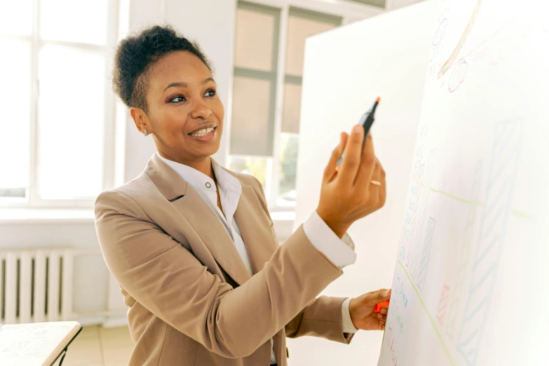 a woman in a business suit writing on a white board, pexels, african american young woman, teaching, light toned, bold graphics