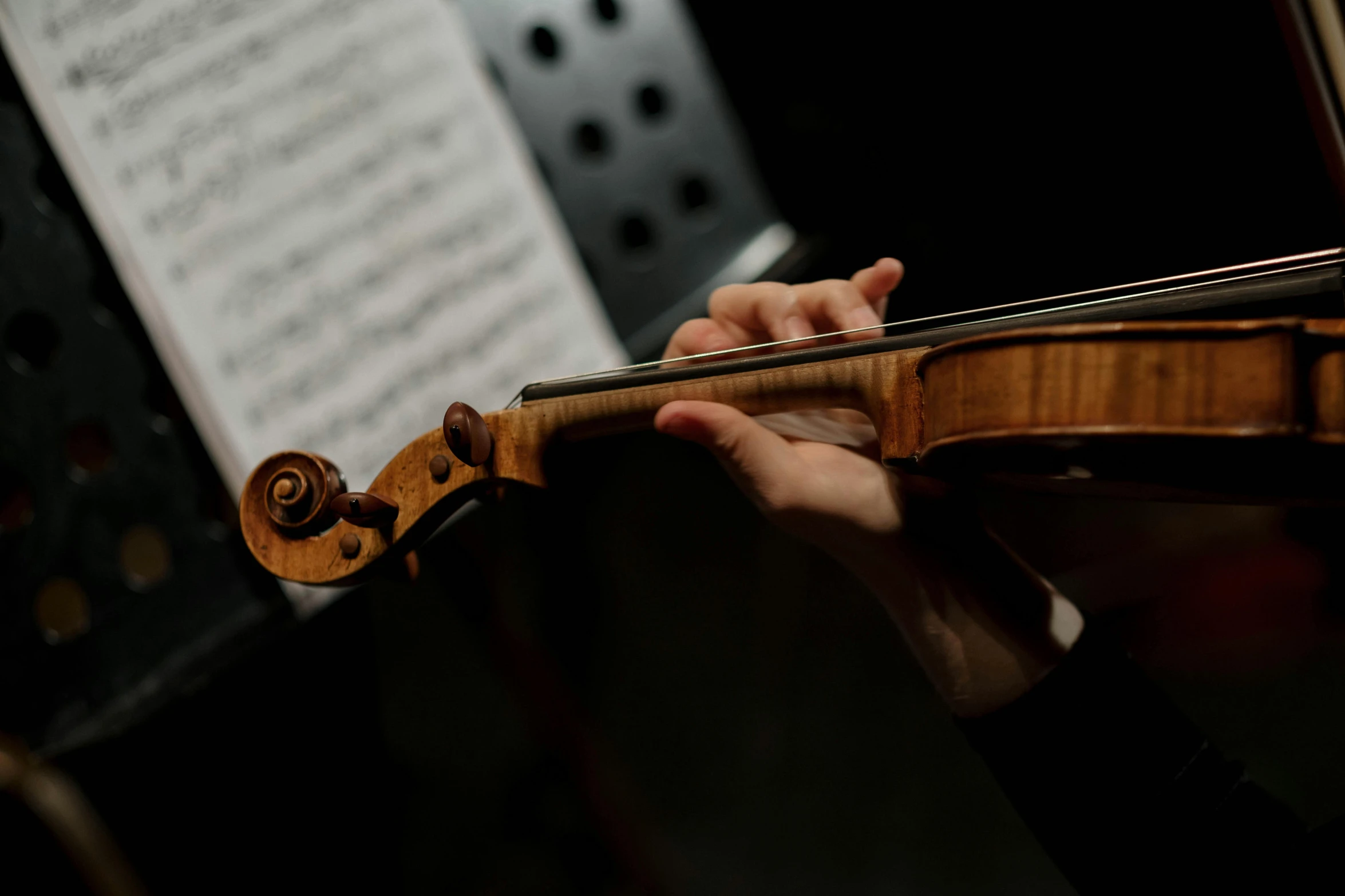a close up of a person playing a violin
