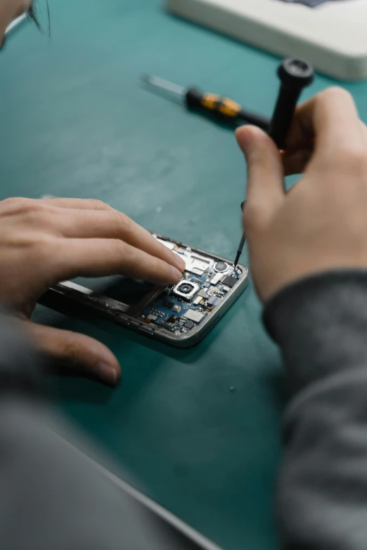 a close up of a person working on a cell phone, adafruit, ilustration, wrecked technology, ideas