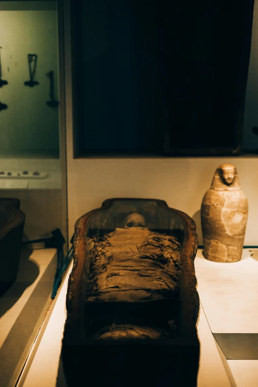 a couple of vases sitting on top of a table, egyptian art, by Daniel Lieske, trending on unsplash, mingei, mummified in bandages, small bed not made, illuminated, photograph taken in 1989