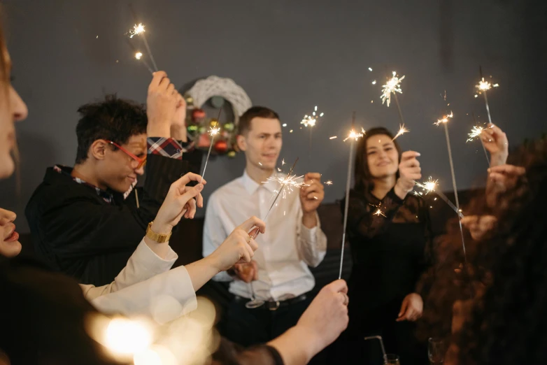 a group of people holding sparklers in their hands, profile image, digital image