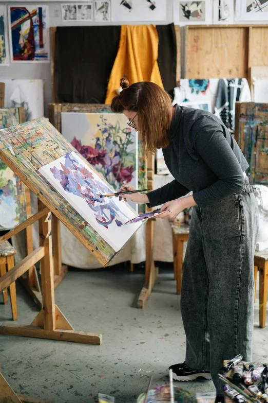 a woman working on a painting in a studio, by Helen Stevenson, trending on pexels, may gibbs, rectangle, art stand, ilustration