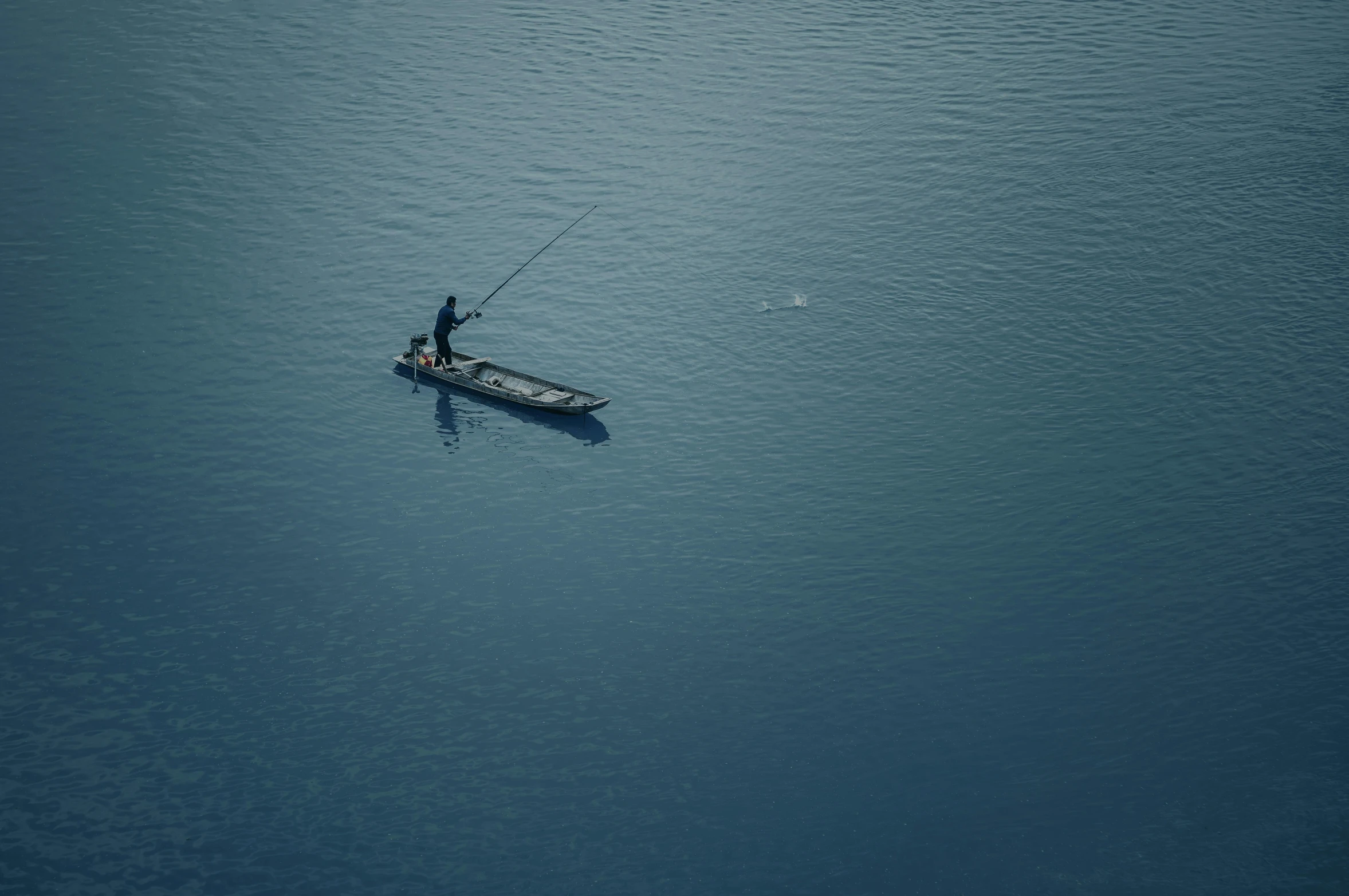 a man in a small boat on a large body of water, a picture, pexels contest winner, minimalism, fishing, dark blue water, rectangle, higly intricate