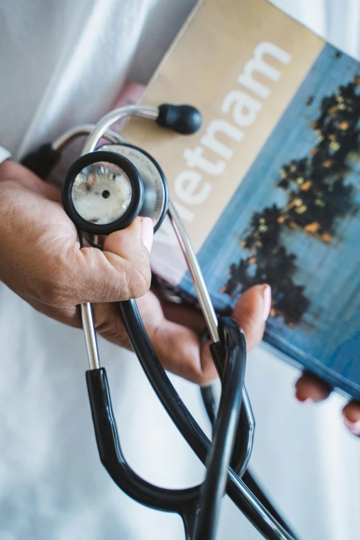 a person holding a book and a stethoscope, a picture, thumbnail, upclose, ap news photo, travel