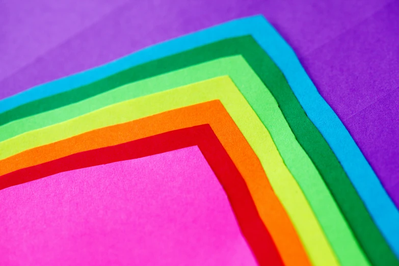 a pile of colored paper sitting on top of a table, inspired by Okuda Gensō, pexels, color field, purple neon colours, medium closeup shot, thumbnail, squares