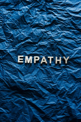 a blue crumpled paper with the word empathy written on it, thumbnail, album cover, philosophy, gettyimages