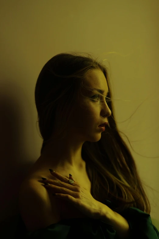 a woman with long hair standing in front of a wall, inspired by Elsa Bleda, pexels contest winner, dark. studio lighting, still from a music video, portrait sophie mudd, taken in the late 2010s