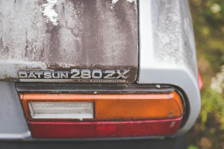 a close up of the rear end of a car, by David Simpson, unsplash, purism, two suns, 1980s photo, insignia, subaru