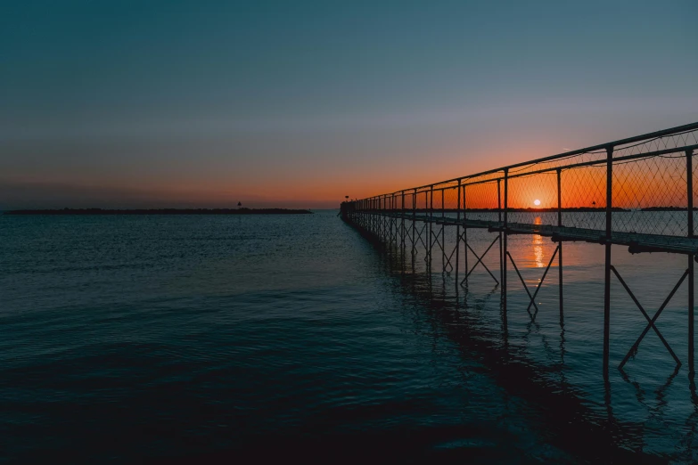 a bridge over a body of water at sunset, by Jesper Knudsen, unsplash contest winner, red sea, lake blue, bridges and railings, plain background