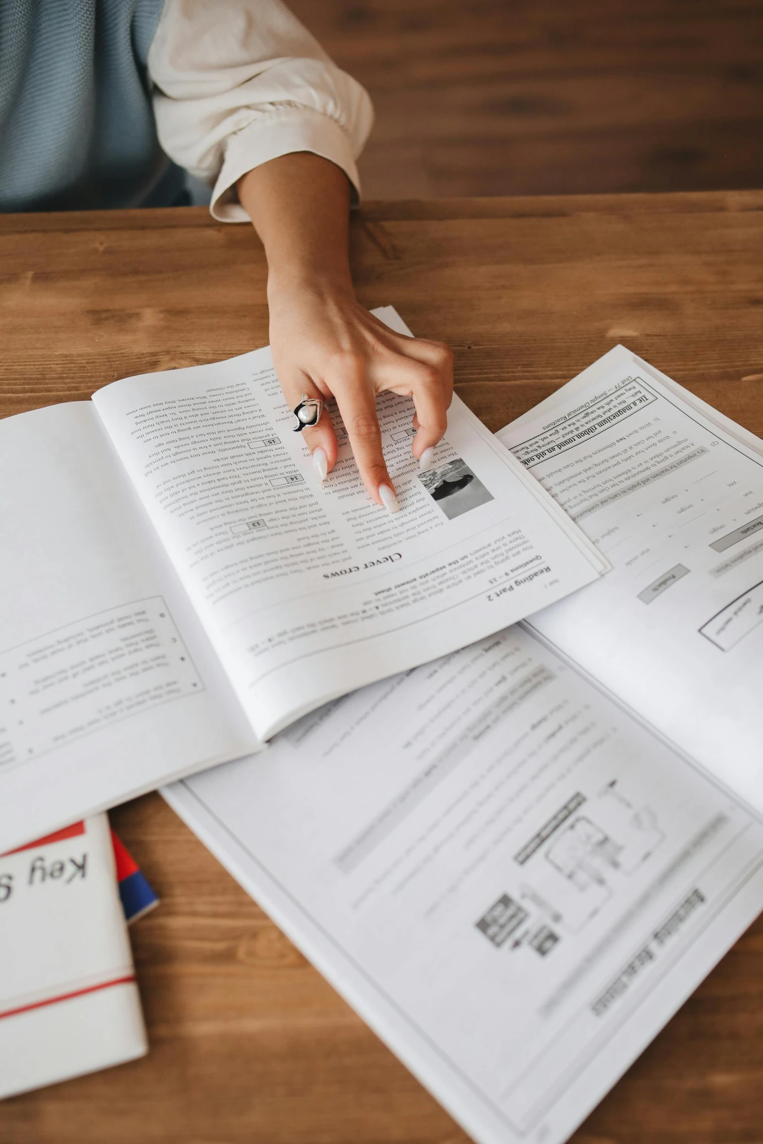 a person sitting at a table with papers and a calculator, informative guide, multiple stories, high-quality photo, customers