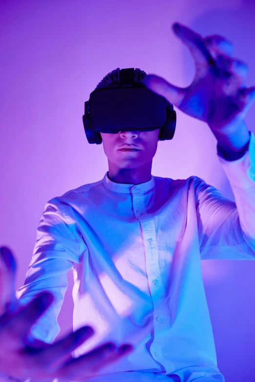 a man in a white shirt wearing a virtual reality headset, a hologram, trending on pexels, interactive art, wearing purple headphones, indigo, nvidia promotional image, year 2099