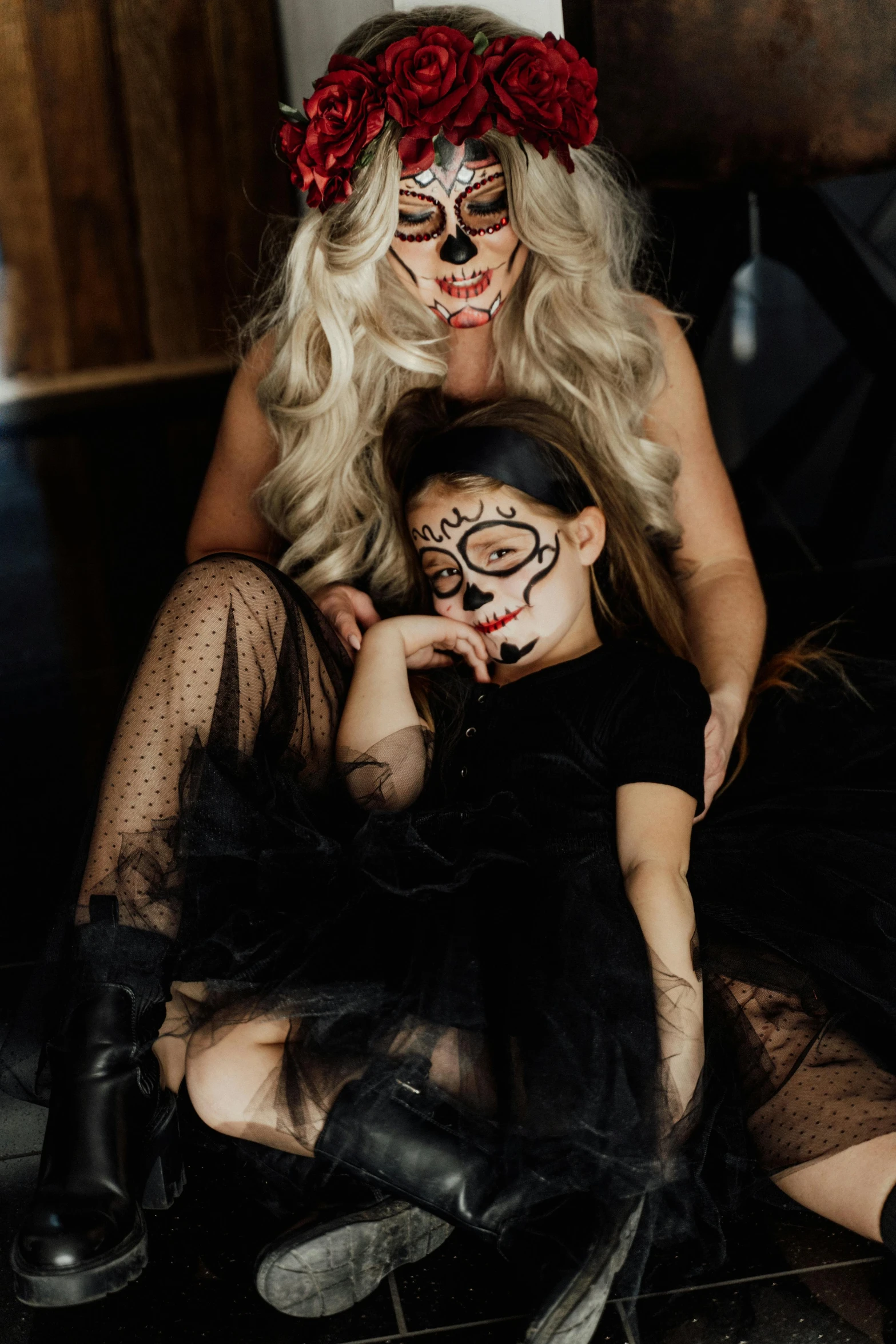 a woman and a child dressed up in halloween costumes, a portrait, trending on pexels, black cat, blond, flatlay, low quality photo