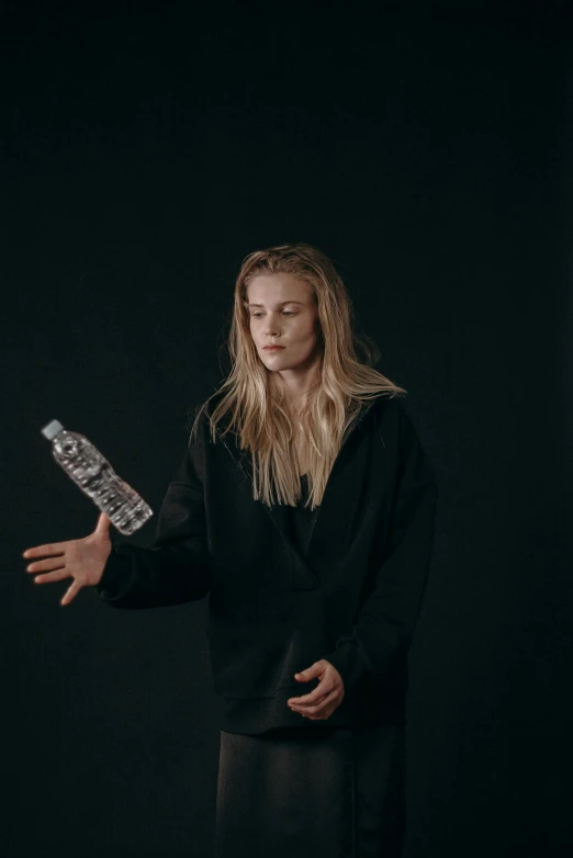 a woman holding a knife in one hand and a bottle in the other, pexels contest winner, hyperrealism, yung lean, with long blond hair, dark dance photography aesthetic, water bottle queen