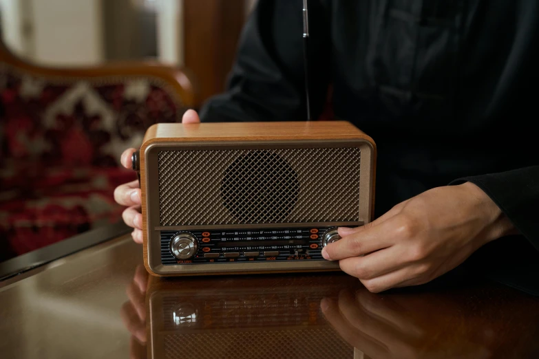 a close up of a person holding a radio, wood effect, rectangle, product shot, premium quality