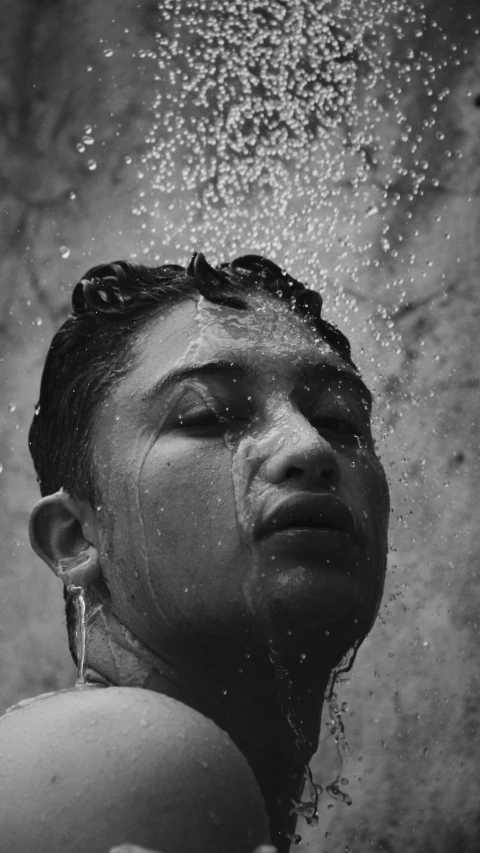 a black and white photo of a woman in the shower, inspired by Lucio Fontana, pexels contest winner, selena quintanilla perez, dripping with oil in the head, summer weather, 1940s photo