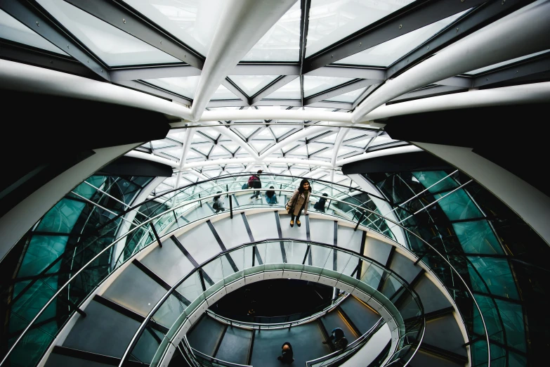 a spiral staircase in the middle of a building, inspired by Zaha Hadid, unsplash contest winner, big ben, geodesic domes, people walking around, thumbnail