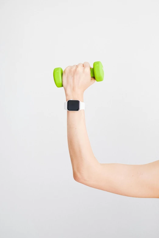 a woman holding a pair of green dumbbells, a digital rendering, pexels contest winner, hypermodernism, wearing a watch, square, lifting weights, with a white background