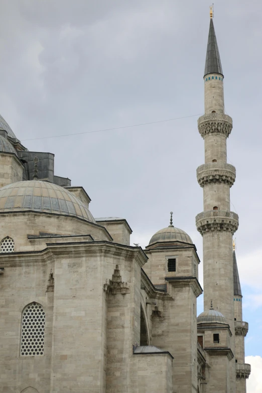 a group of people standing in front of a large building, a marble sculpture, inspired by Altoon Sultan, trending on unsplash, hurufiyya, lead - covered spire, front and side views, close - up photo, tiled roofs