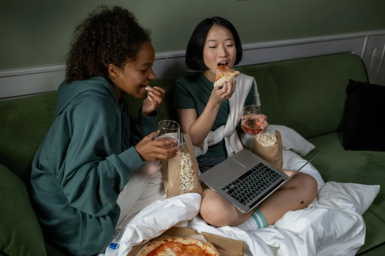 two women sitting on a couch eating pizza, pexels contest winner, renaissance, young asian girl, sitting on a bed, everything fits on the screen, college students