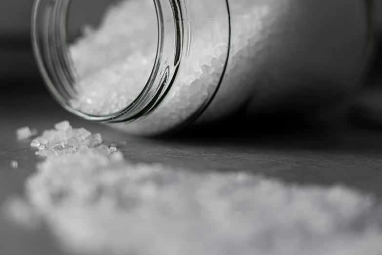 a close up of a jar of salt on a table, pexels, hyperrealism, flattened, rice, gif, abstraction chemicals