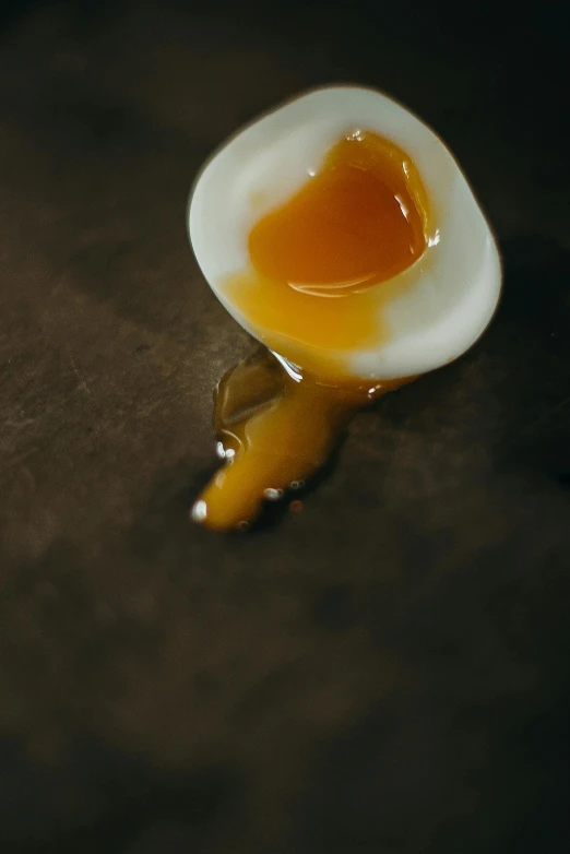 a broken egg sitting on top of a table, a picture, trending on pexels, brown sauce, tear drops, koju morimoto, long